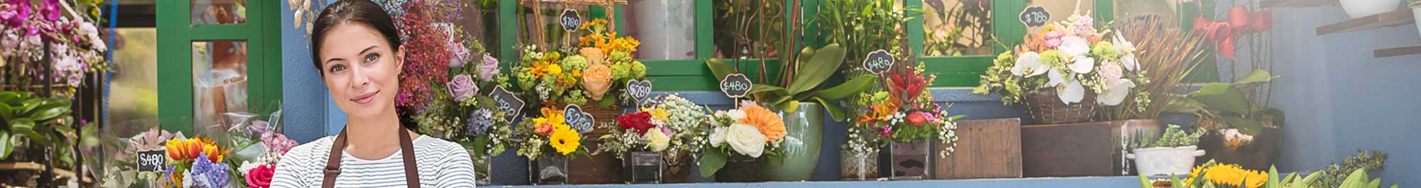 small business owner standing in front of her flower shop