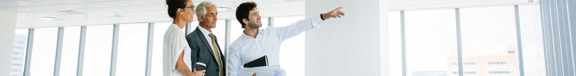 real estate agent showing two clients a commercial property